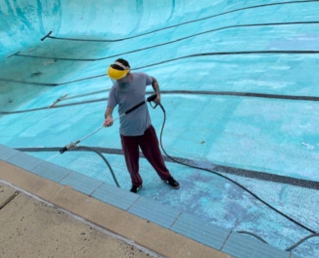 ADAPPT volunteer Michael cleans pool
