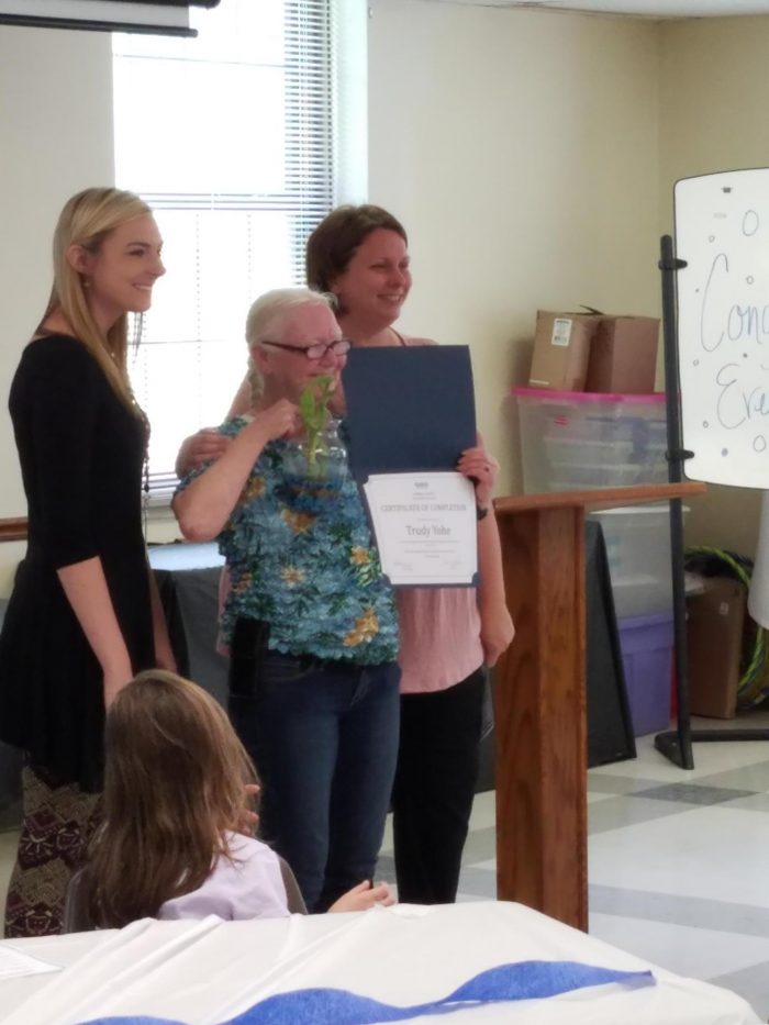 Photo: A graduate from Cambria DRC accepts a certificate for her achievement