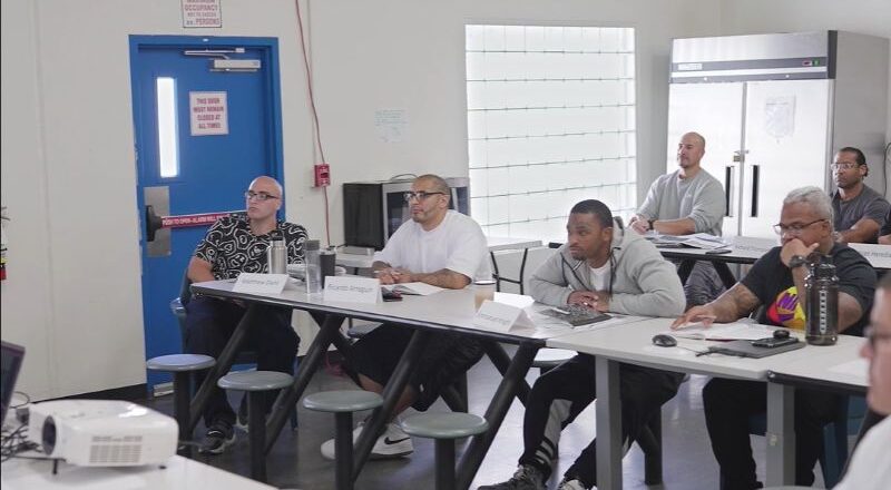 Participants attending a group session at a GEO Reentry Services day reporting center