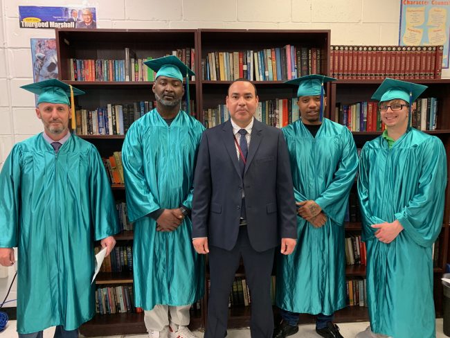 Harbor RRC Education Manager Fredy Yanes and the three vocational graduates.