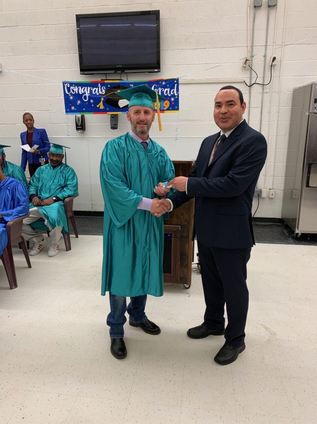 Education Manager Fredy Yanes Awards Valedictorian Eugene R