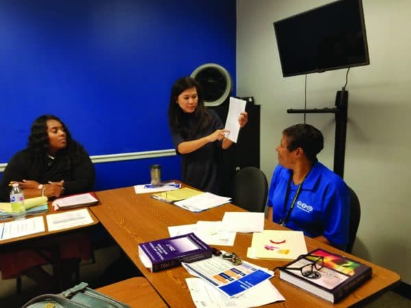 GEO staff members review training materials