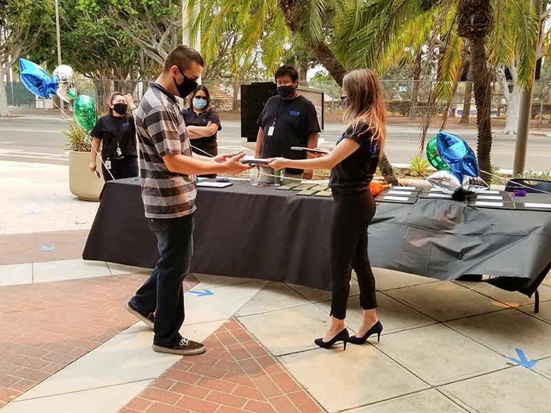 During COVID-19, drive-through transition ceremonies ensure graduating participants get credit