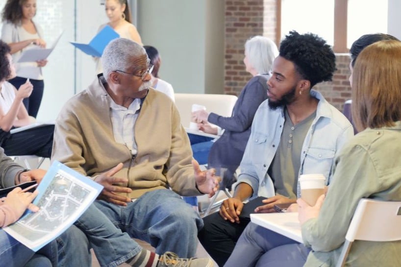 Diverse group of people discussing issues in their local community.