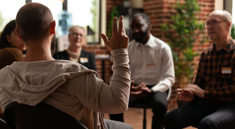 man with addiction sharing with group