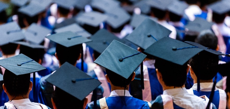 Graduates in caps and gowns at a ceremony, representing Perry County reentry program.