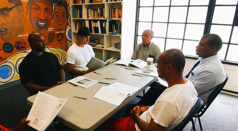 Participants attending a group meeting at a GEO Reentry Services facility
