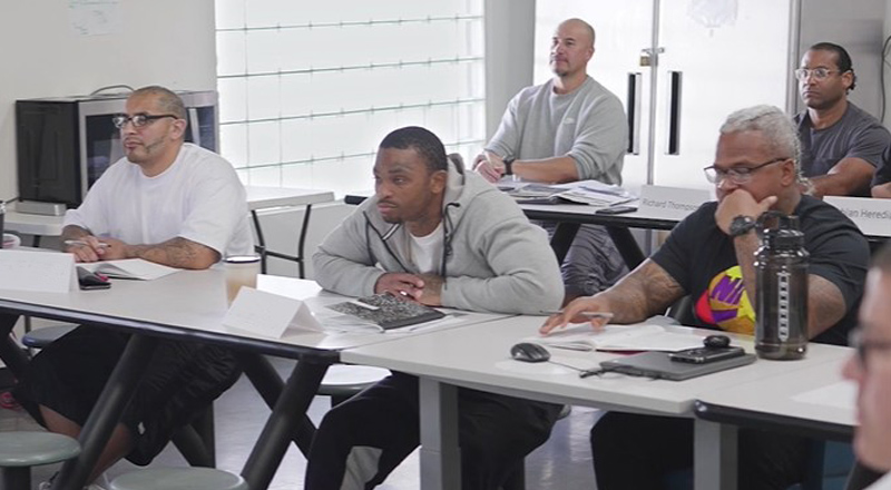Participants attending a group session at a GEO Reentry Services day reporting center
